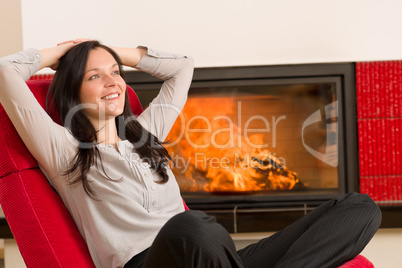 Winter home fireplace woman relax red armchair