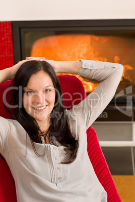 Winter home fireplace woman relax red armchair