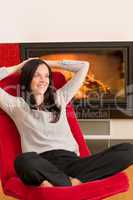 Winter home fireplace woman relax red armchair