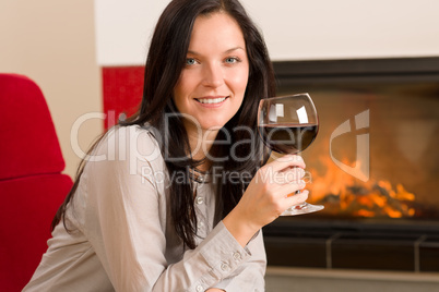 Winter home fireplace woman glass red wine