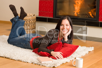 Home living happy woman lying by fireplace