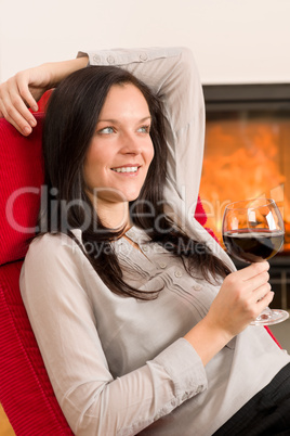 Winter home fireplace woman glass red wine