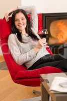 Winter home fireplace woman glass red wine