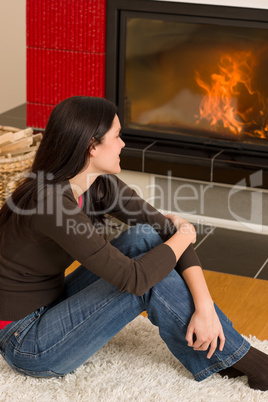 Woman looking into fireplace