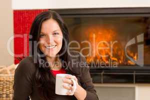 Winter home fireplace woman drink hot coffee