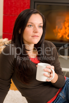 Winter home fireplace woman drink hot coffee
