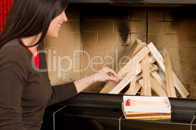 Home fireplace woman lighting up wooden logs