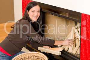 Home fireplace woman put logs happy winter