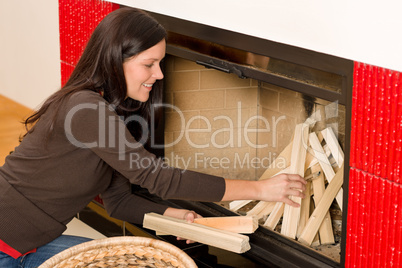 Home fireplace woman put logs happy winter