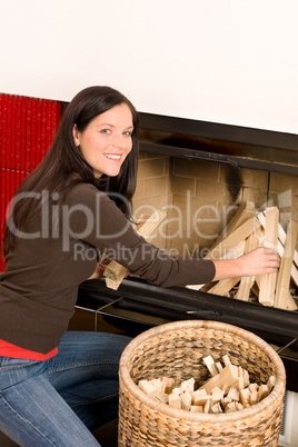 Home fireplace woman put logs happy winter