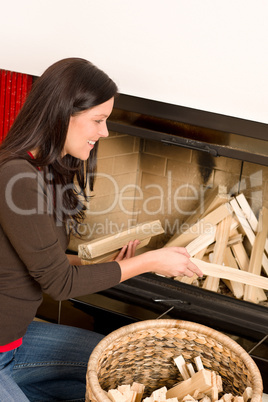 Home fireplace woman put logs happy winter