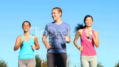Three Young Friends Jogging Together