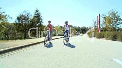 Caucasian Female Friends Cycling on Suburban Roads