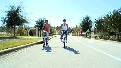 Healthy Female Friends Cycling Together