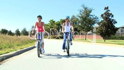 Fit Young Female Friends Cycling Together