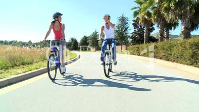 Female Friends Cycling Together