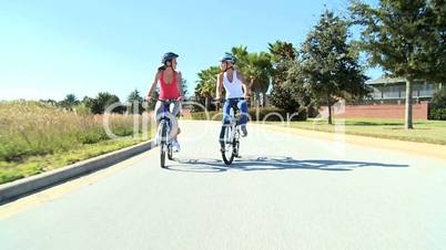 Caucasian Female Friends Cycling on Suburban Roads
