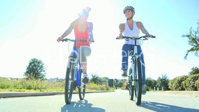 Female Friends Cycling Together