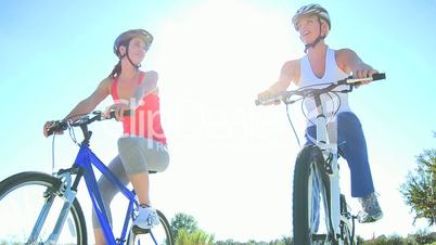 Caucasian Female Friends Cycling on Suburban Roads