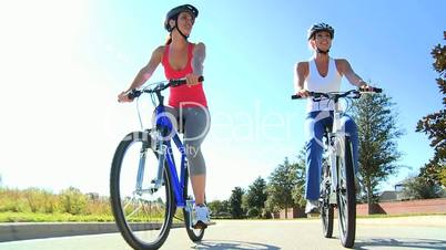 Healthy Female Friends Cycling Together