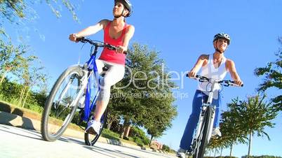 Caucasian Female Friends Cycling on Suburban Roads