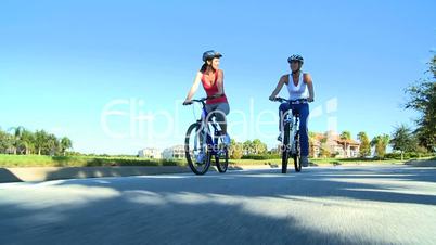 Healthy Female Friends Cycling Together