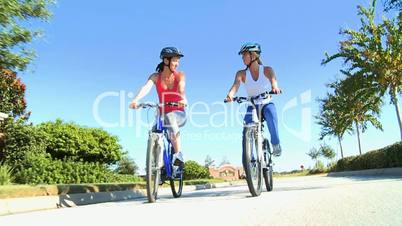 Caucasian Female Friends Cycling on Suburban Roads