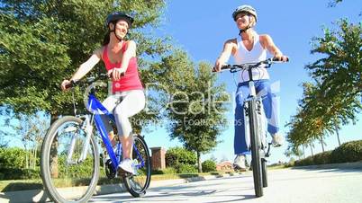 Healthy Female Friends Cycling Together