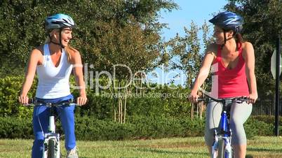 Caucasian Female Friends Cycling on Suburban Roads