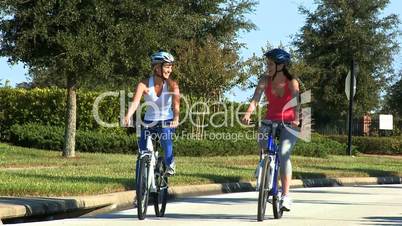 Caucasian Female Friends Cycling on Suburban Roads