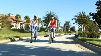 Healthy Female Friends Cycling Together