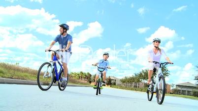 Caucasian Family Group Cycling Outdoors