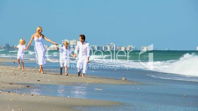 Happy Caucasian Family Running on Beach