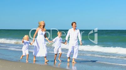 Attractive Young Family Group on Beach