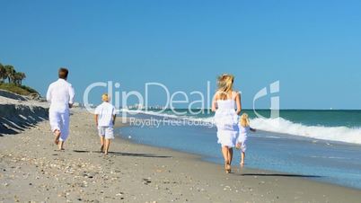 Happy Caucasian Family Running on Beach