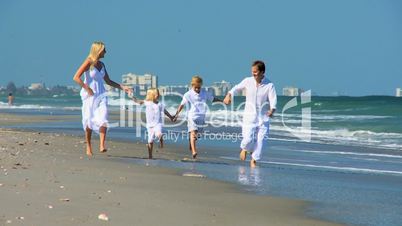 Happy Caucasian Family Running on Beach