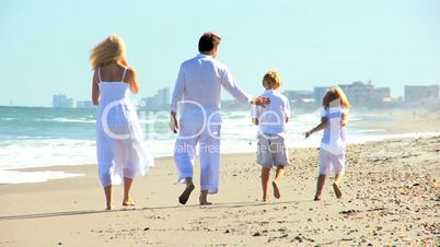 Happy Caucasian Family Running on Beach