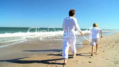 Young Caucasian Family Running on Beach