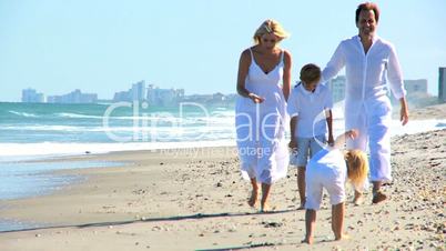 Happy Caucasian Family Walking on Beach