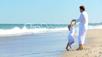 Father and Young Daughter Playing on the Beach