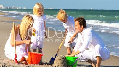 Happy Children and Parents Playing in the Sand