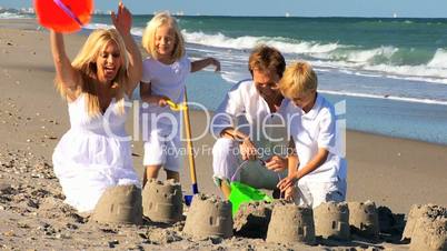Caucasian Family Building Sand Castles