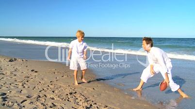 Blonde Father and Son on Beach Playing Ball