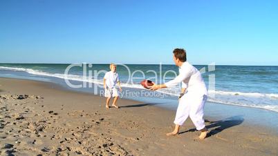 Young Father and Son Playing Ball on a Beach