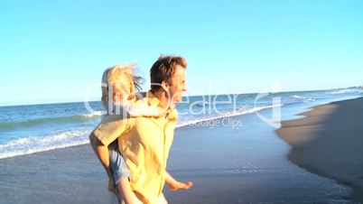 Caucasian Parents Having Fun on Beach with Children