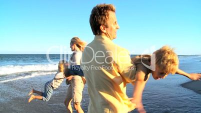 Caucasian Parents Playing with Their Children on Beach