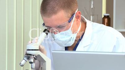 Male Medical Student with Microscope and Laptop