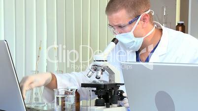 Male Medical Student with Microscope and Laptop