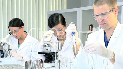Three Research Students Working in Medical Laboratory