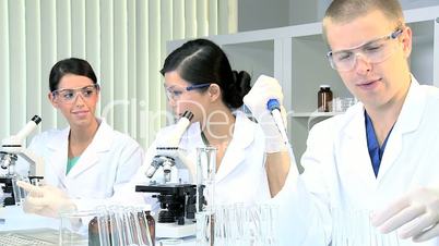 Three Student Doctors Working in Hospital Laboratory